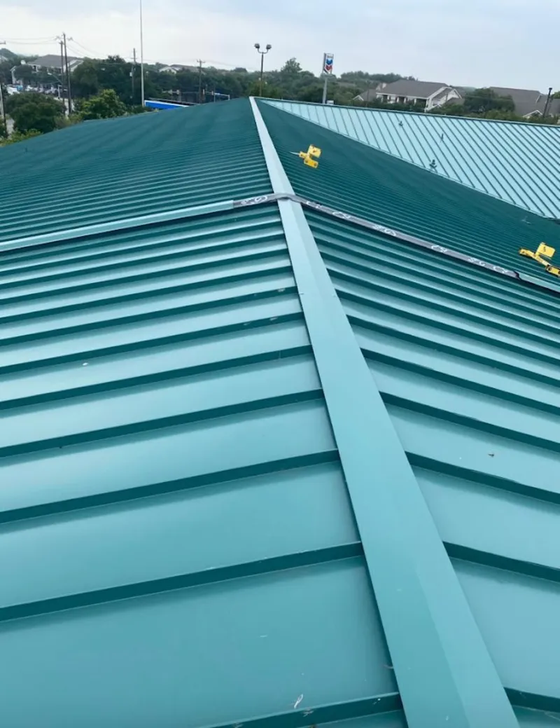Green commercial metal roof ridge and valley for Metal Roof Repair in The Woodlands
